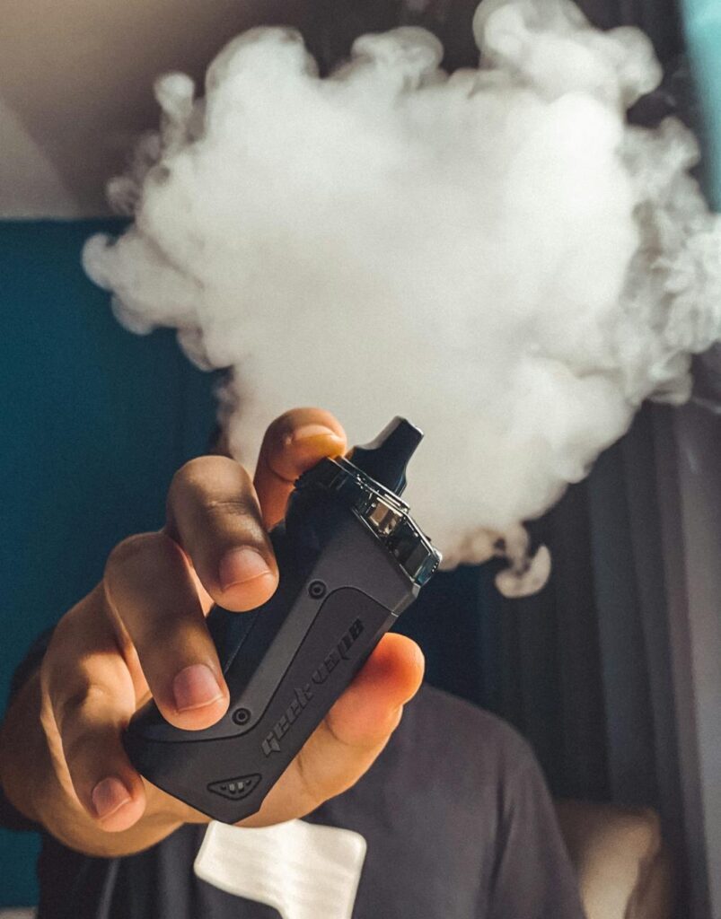 person holding black vape